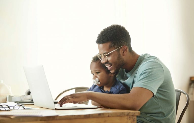 IInternational Step-By-Step Association - Success Story | Father and son working on a laptop