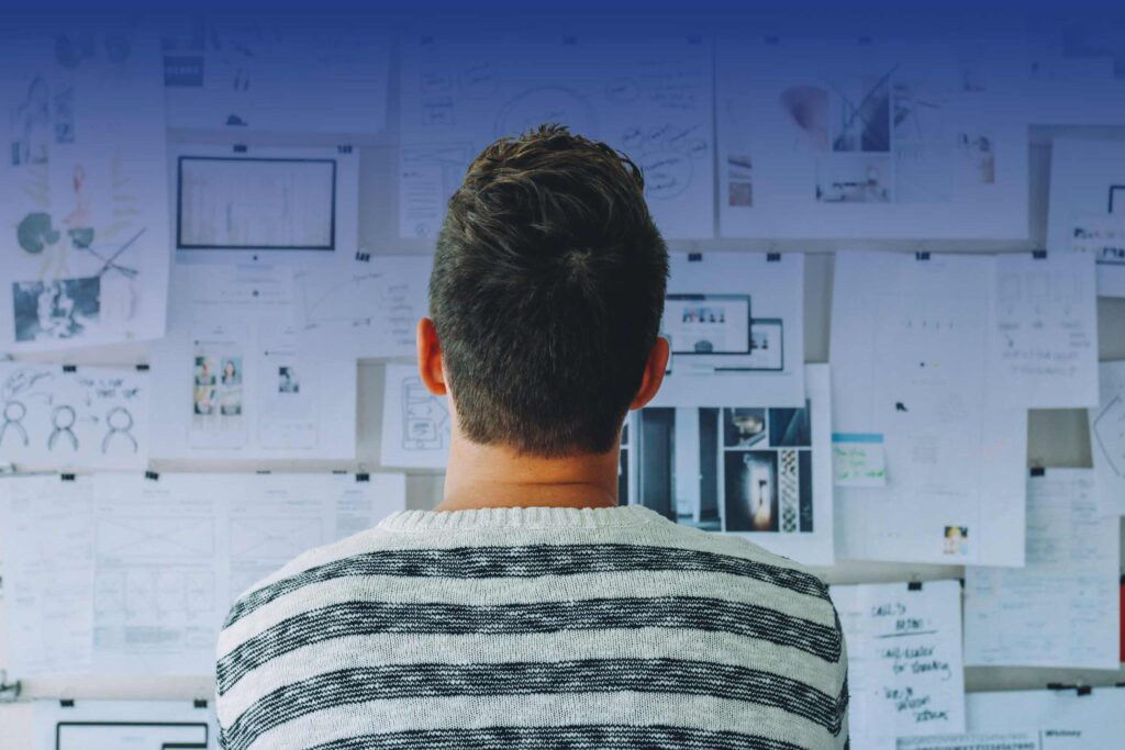 MC Consulting | Strategy Maps NGOs INGOs | Person looking at a planning board on a wall