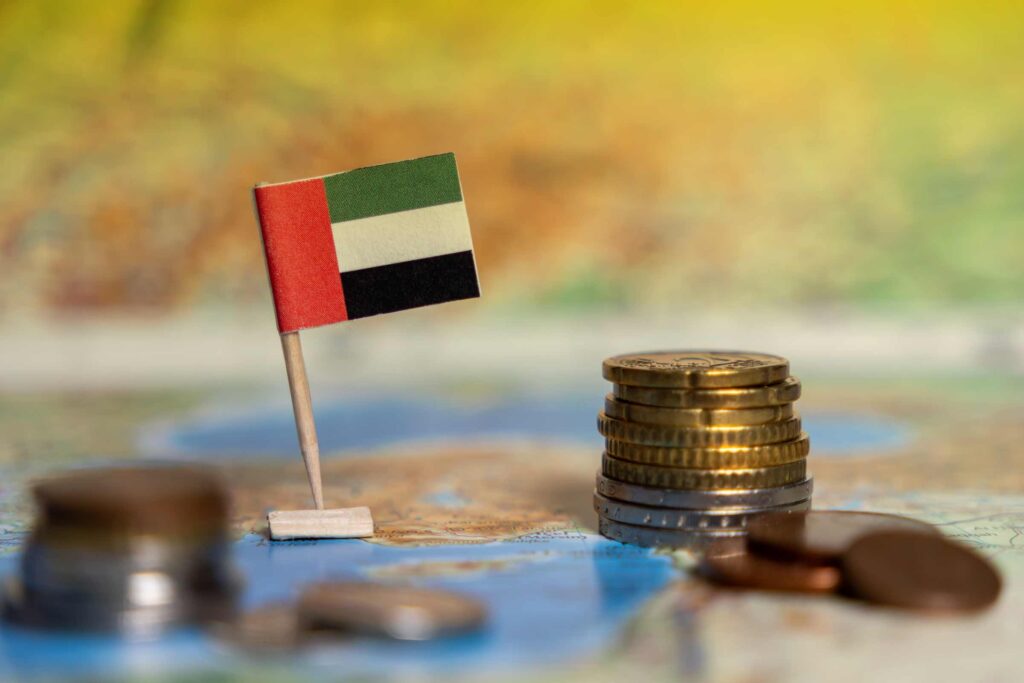 =mc consulting | A flag and a coin sitting on a map